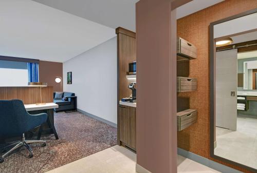 an office with a desk and a chair in a room at Hilton Garden Inn Madison Huntsville Airport in Madison