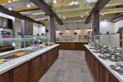 une grande cuisine avec une ligne de buffet dans un restaurant dans l'établissement Hotel Auburn Hills, à Auburn Hills
