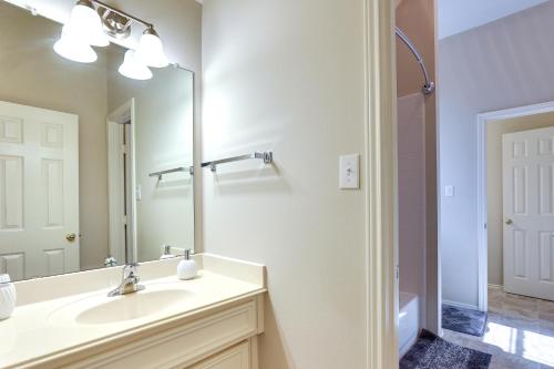 a bathroom with a sink and a mirror at Spacious Sugar Land Retreat with Fireplace and Yard in Sugar Land