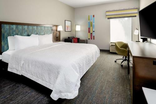 a hotel room with a large bed and a desk at Hampton Inn Richmond/Midlothian Turnpike in Midlothian