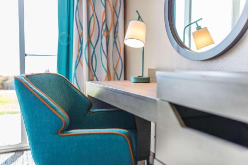 a desk with a chair and a mirror at Hampton Inn Virginia Beach Oceanfront North in Virginia Beach