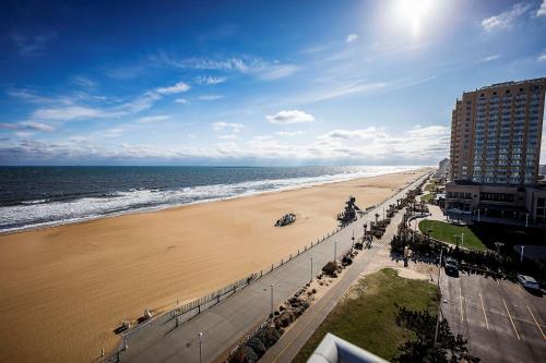 a view of a beach with a building and the ocean at Hampton Inn Virginia Beach Oceanfront North in Virginia Beach