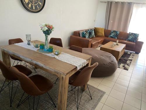 een woonkamer met een tafel en een bank bij Sandton Accomodation Stay in Johannesburg