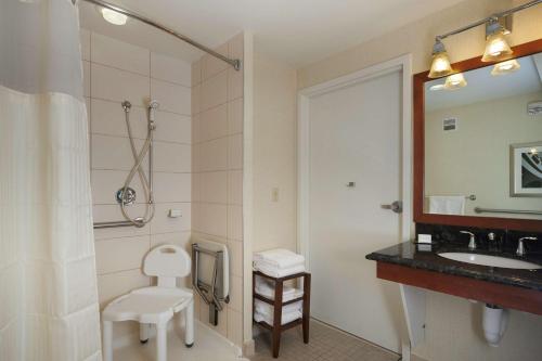 a bathroom with a sink and a toilet and a mirror at Doubletree by Hilton Hotel Williamsburg in Williamsburg
