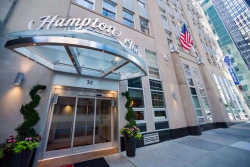 an entrance to a hampton hotel with an american flag at Hampton Inn Manhattan/Downtown- Financial District in New York