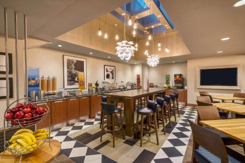 a restaurant with a breakfast bar and tables and chairs at Hampton Inn Manhattan/Downtown- Financial District in New York