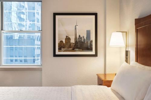 a hotel room with a picture of a city at Hampton Inn Manhattan/Downtown- Financial District in New York
