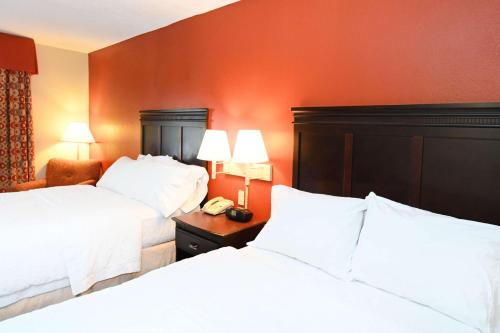 a hotel room with two beds with white sheets at Hampton Inn Richmond-SW Hull Street in Midlothian