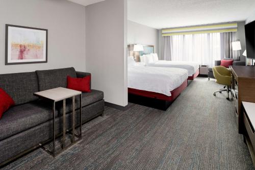 a hotel room with a bed and a couch at Hampton Inn Richmond-SW Hull Street in Midlothian