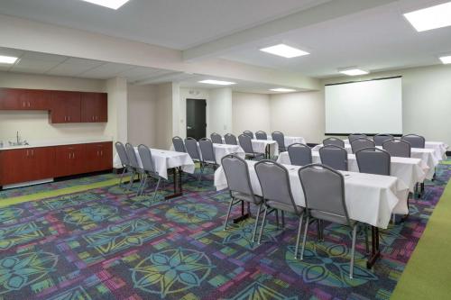 a conference room with tables and chairs and a whiteboard at Hampton Inn Hopewell Fort Gregg-Adams in Hopewell