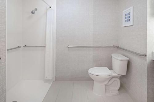 a white bathroom with a toilet and a shower at Hampton Inn Richmond-West Innsbrook in Broad Meadows