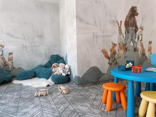 a room with colorful tables and animals on the floor at Dom Górski 878 mnpm in Zakopane