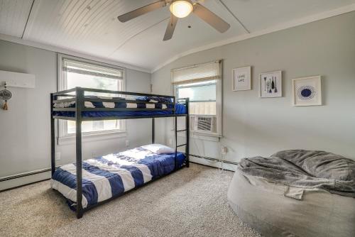 a bedroom with two bunk beds and a ceiling fan at Downtown Russells Point Cottage Near Indian Lake! in Russells Point