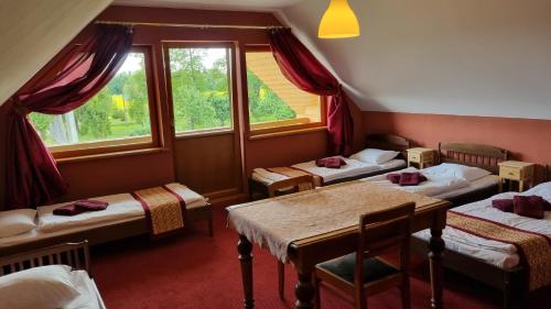 的住宿－Viki talu，带四张床、桌子和窗户的客房