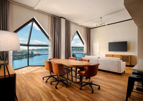 a living room with a table and chairs and a bedroom at The Landing at Hampton Marina, Tapestry Collection by Hilton in Hampton
