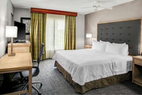 a hotel room with a bed and a desk at Homewood Suites by Hilton Richmond - West End / Innsbrook in Broad Meadows