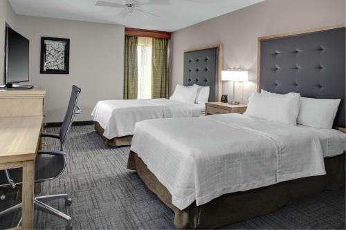a hotel room with two beds and a desk at Homewood Suites by Hilton Richmond - West End / Innsbrook in Broad Meadows