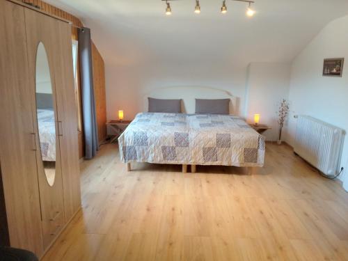 a bedroom with a bed and two candles on a wooden floor at Ferienwohnung in ruhiger Waldrandlage in Bad Wildbad