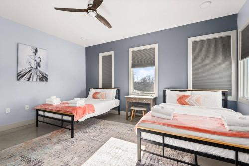 two beds in a room with two windows at Alloy 374-7 in Nashville