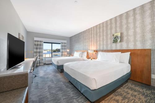 a hotel room with two beds and a flat screen tv at Hilton Garden Inn Fremont Milpitas in Fremont