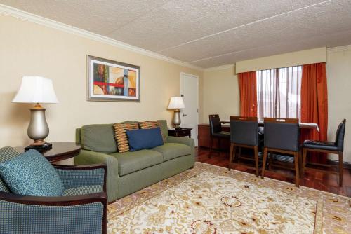 a living room with a couch and a dining room at DoubleTree by Hilton Hotel Grand Rapids Airport in Grand Rapids