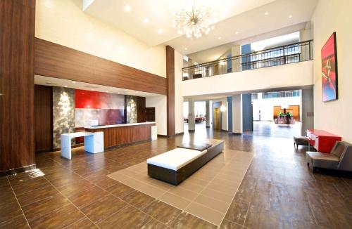 a lobby of a hospital with a couch and chairs at Embassy Suites by Hilton Detroit - Livonia/Novi in Livonia