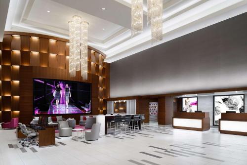 a lobby with a large television and a dance floor at Hilton Woodland Hills/ Los Angeles in Woodland Hills