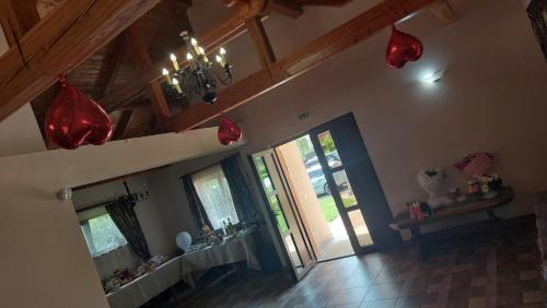 a living room with red decorations on the ceiling at Pensiunea Romosan in Cucuiş