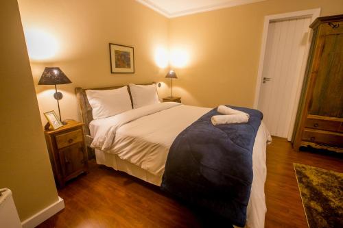 a bedroom with a large bed and a wooden floor at Villa Don in Petrópolis