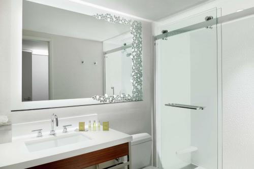 a bathroom with a sink and a mirror at DoubleTree Suites by Hilton Phoenix in Phoenix