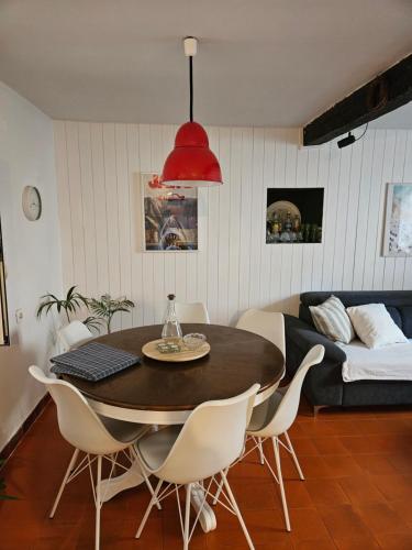a dining room with a table and chairs and a couch at Plavo bijeli svijet in Preko