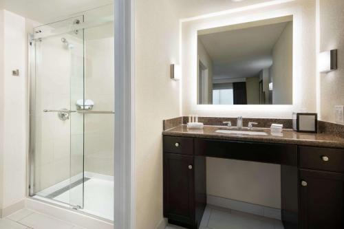 a bathroom with a sink and a mirror at Homewood Suites by Hilton-Anaheim in Anaheim