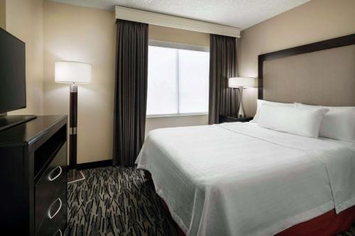 a hotel room with a large bed and a window at Homewood Suites by Hilton-Anaheim in Anaheim
