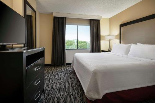 um quarto de hotel com uma cama e uma televisão em Homewood Suites by Hilton-Anaheim em Anaheim