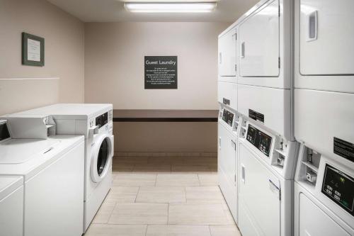 a laundry room with a washer and dryer at Homewood Suites by Hilton-Anaheim in Anaheim