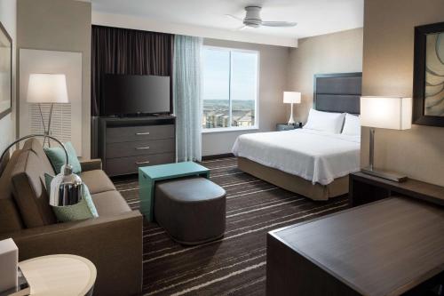 a hotel room with a bed and a couch at Homewood Suites by Hilton Aliso Viejo Laguna Beach in Aliso Viejo