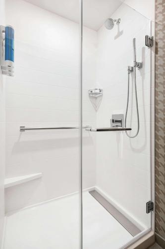 a shower with a glass door in a bathroom at Home2 Suites By Hilton Denver Downtown Convention Center in Denver