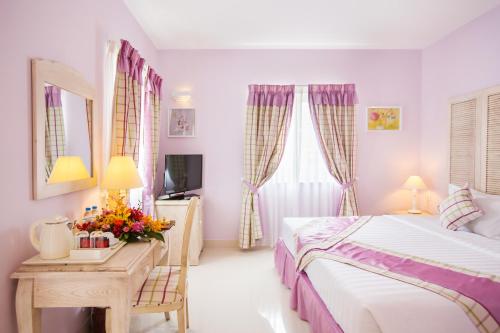 Postel nebo postele na pokoji v ubytování Hotel L'Odéon Phu My Hung