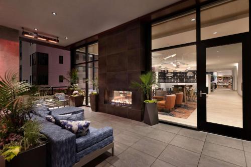a lobby with a couch and a fire place at Hampton Inn & Suites Watertown Boston, Ma in Watertown