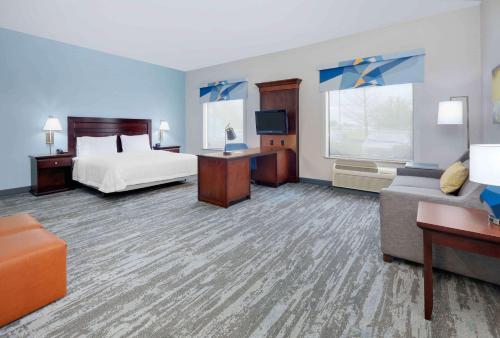 a large hotel room with a bed and a couch at Hampton Inn & Suites Dallas-Arlington-South in Arlington