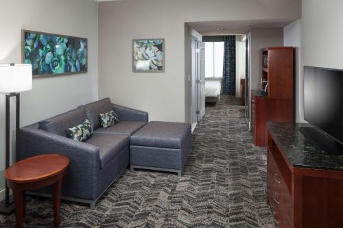 a living room with a couch and a tv at Hilton Garden Inn Tucson Airport in Tucson