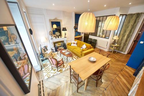 a living room with a table and a yellow couch at Charmant cocon lyonnais Sathonay-Terreaux in Lyon