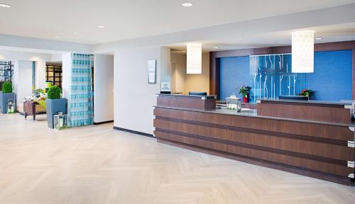 a lobby of a hotel with a waiting room at Hilton Garden Inn Providence in Providence