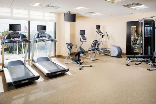 a gym with treadmills and exercise equipment in a room at Hilton Garden Inn Providence in Providence