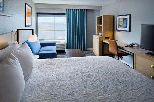 a hotel room with a large bed and a desk at Hilton Garden Inn Providence in Providence