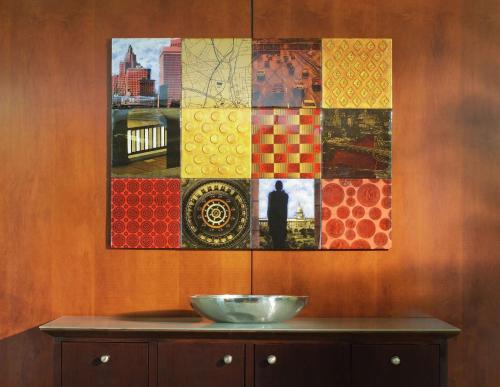 a wall with a painting and a bowl on a cabinet at Hilton Providence in Providence