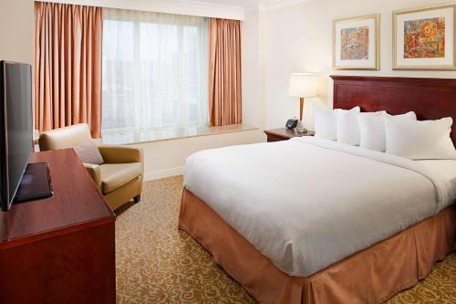 a hotel room with a large bed and a television at Hilton Providence in Providence