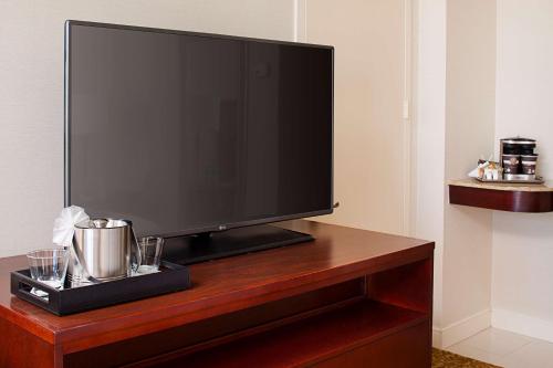 a flat screen tv sitting on top of a wooden table at Hilton Providence in Providence