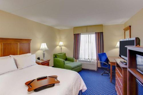 a hotel room with a bed and a television at Hampton Inn and Suites Fredericksburg South in Fredericksburg