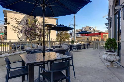 an outdoor patio with tables and chairs and umbrellas at Homewood Suites Nashville Vanderbilt in Nashville